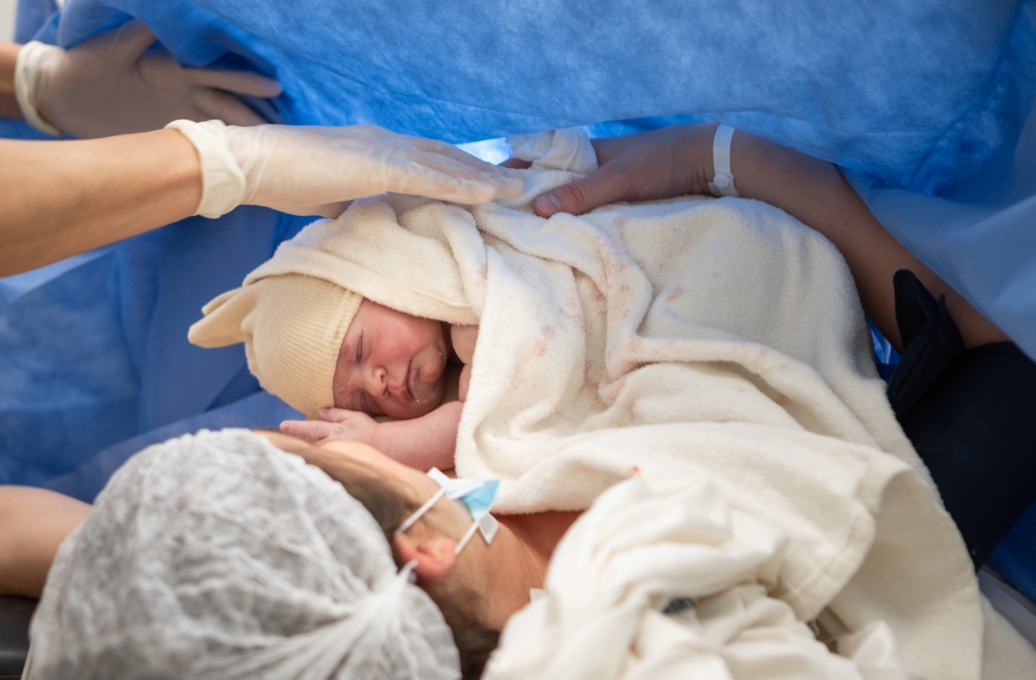 picture of a mother holding her baby right after giving birth