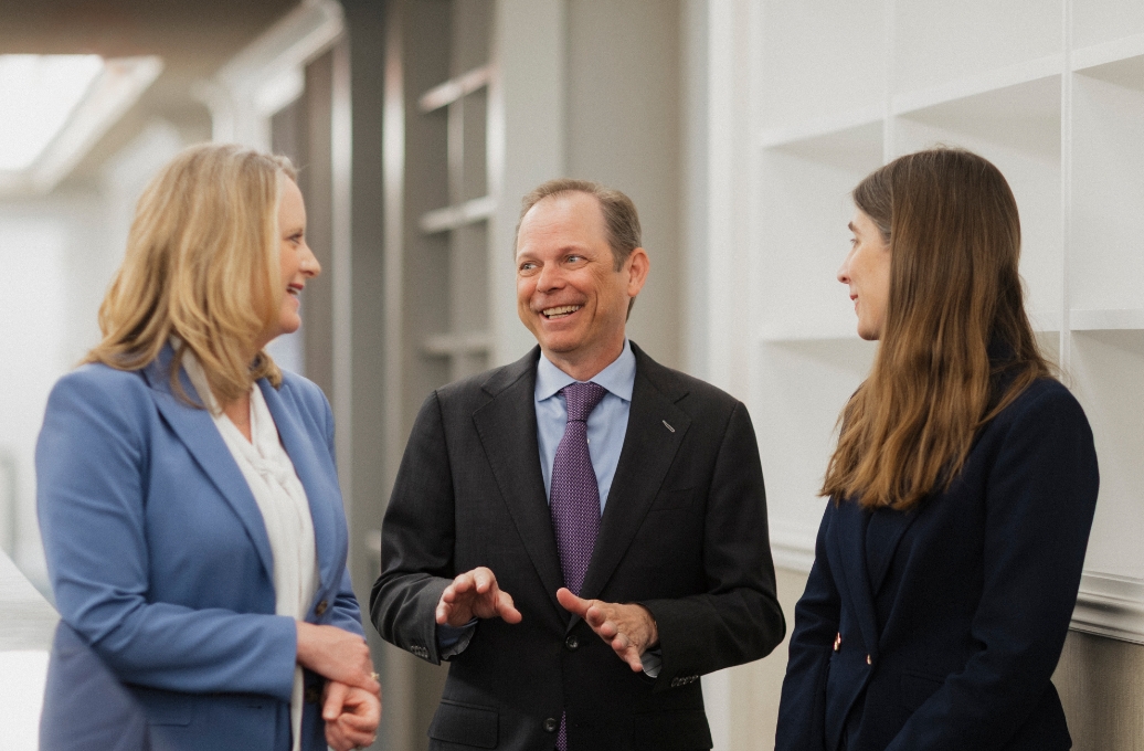Rossiter & Boock attorneys talking a group.