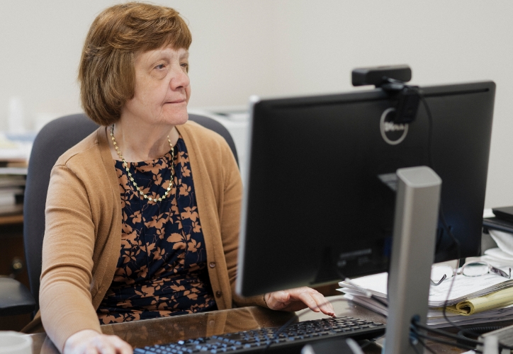 Attorney Nancy Troutman looking at a computer.