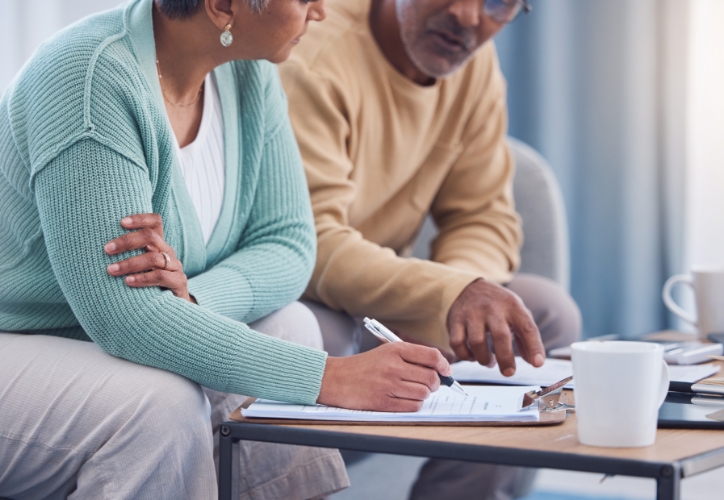 A man and a woman looking at paperwork.
