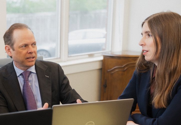 Jaime Boock talking with a fellow attorney