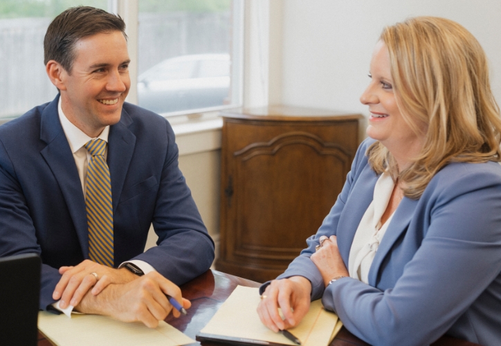 Two Roman & Boock attorneys discussing slip and fall case processes.