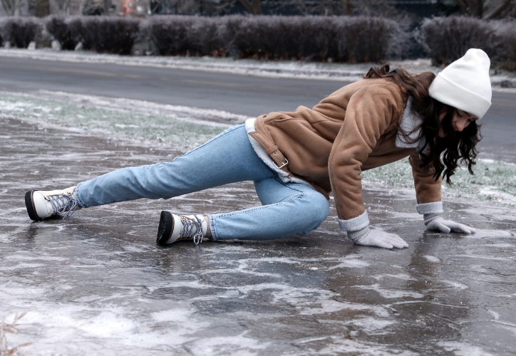 Woman slipping and falling on ice