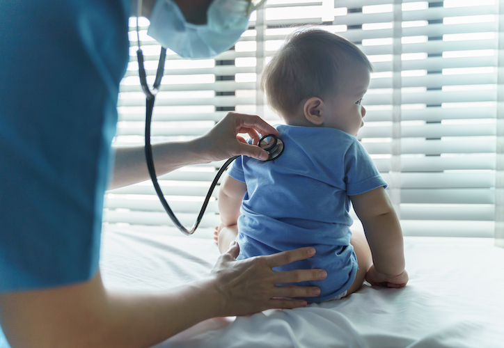 doctor examining a baby patient with stethoscope in medical room at hospital