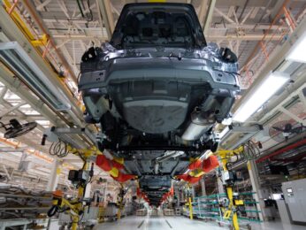 car raised in the air in a shop