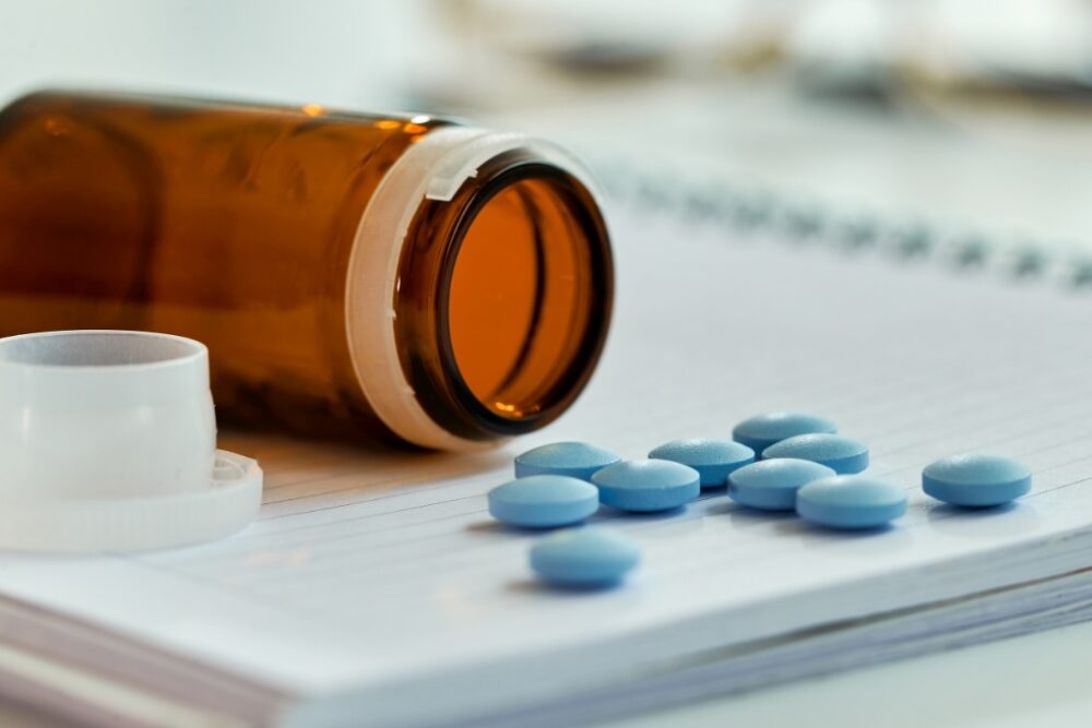 A pill bottle with medication spilling out.