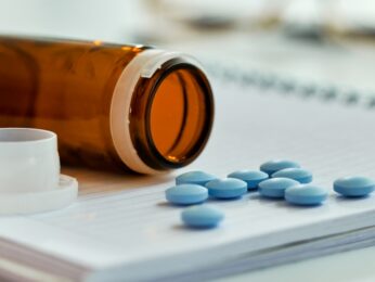 A pill bottle with medication spilling out.