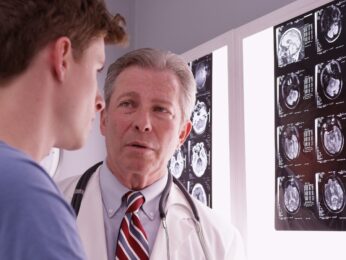 Two doctors looking at brain scans.
